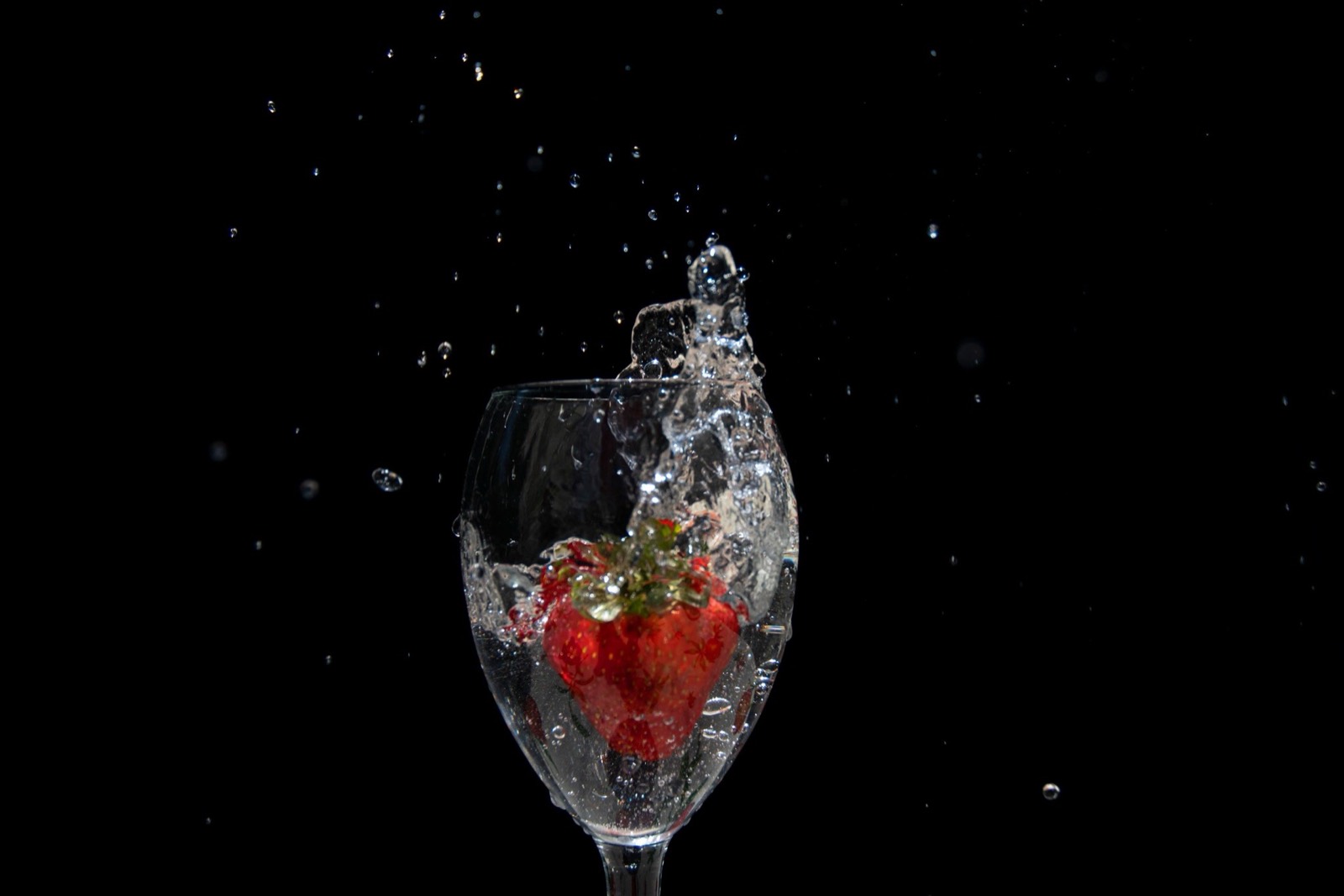Macro shot of a water droplet on a strawberry